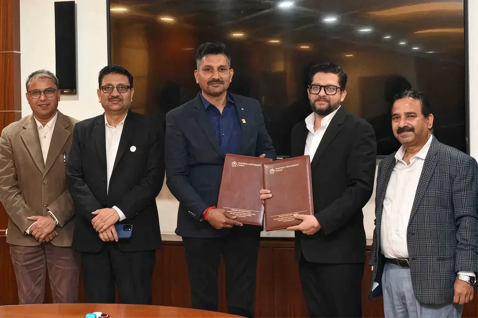 Highness Micro representatives holding a signed agreement